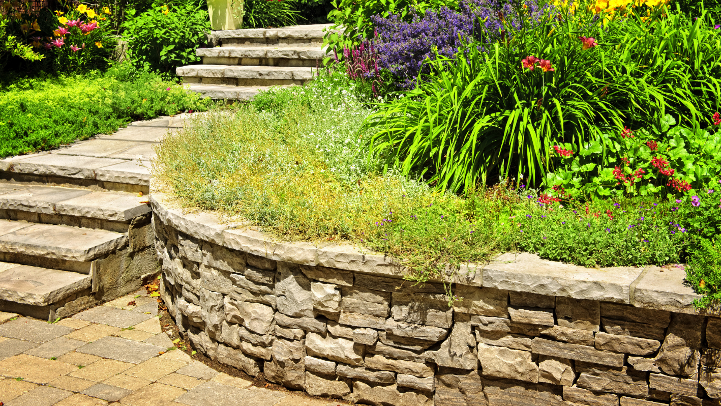 A stone garden wall with steps leading up to it