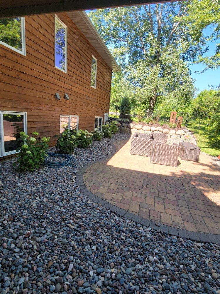 A patio with a table and chairs on it