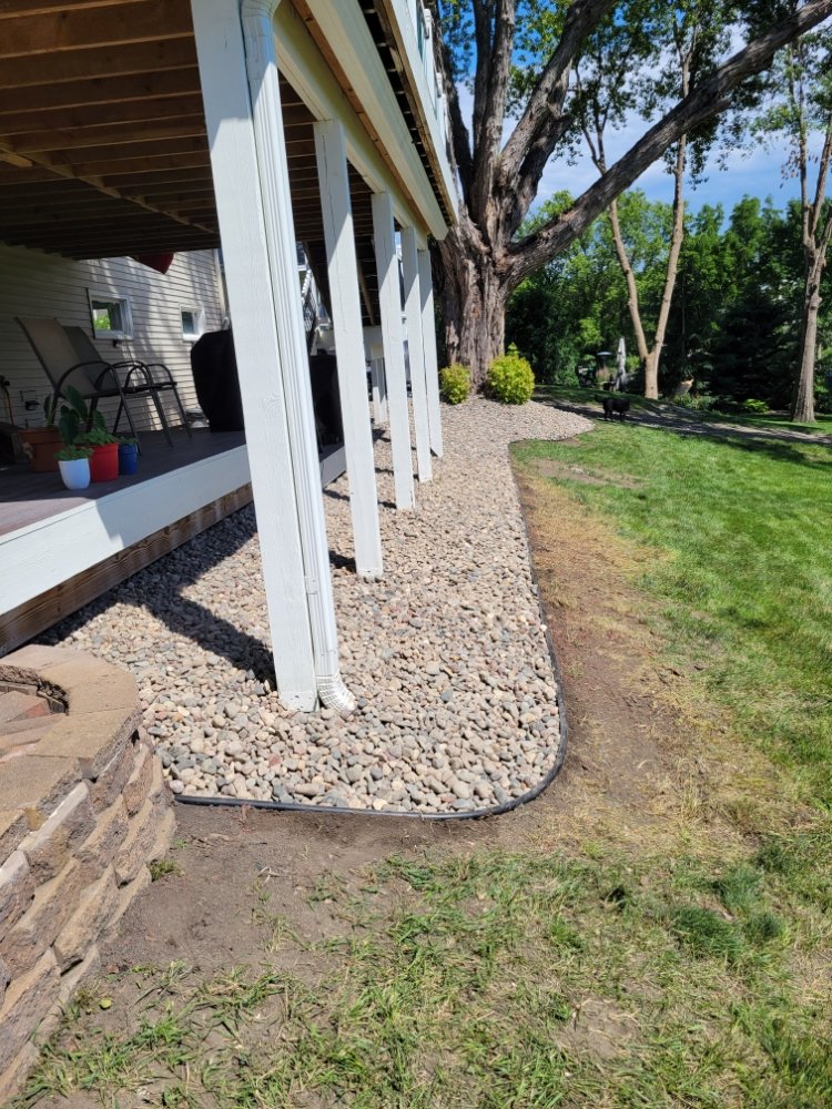 A view of a back yard from the side of a house